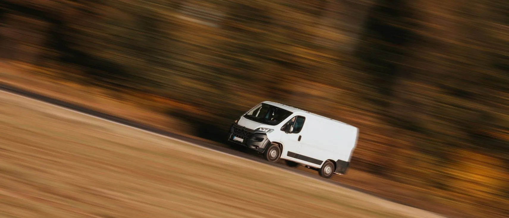 a van on the move — header, wide