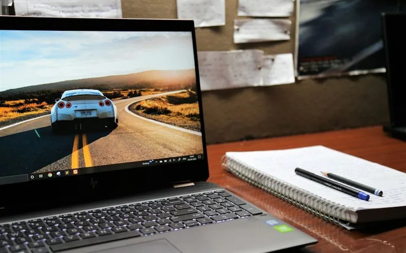 a laptop showing a car on screen — article card